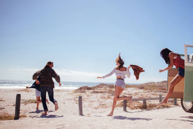 People run for the beach after a long drive